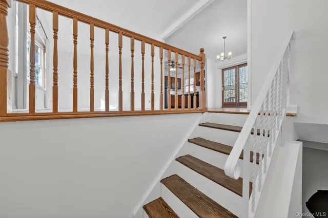 a view of entryway with wooden floor and stairs