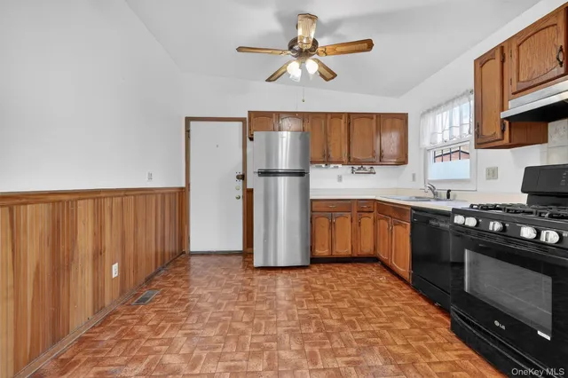 a kitchen with a stove a refrigerator and a sink