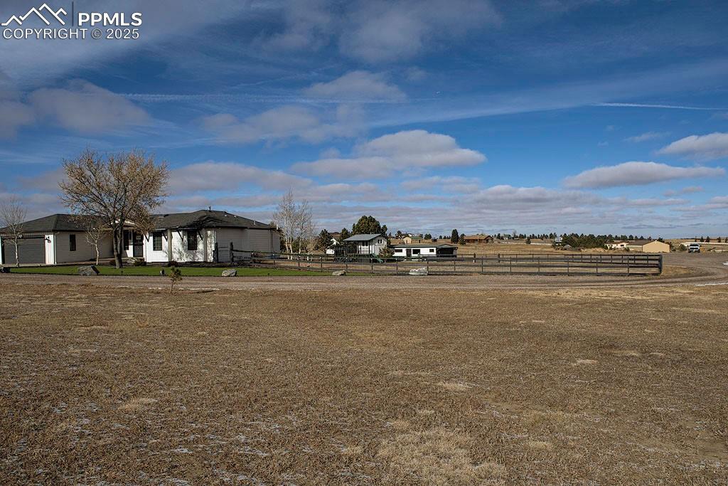 5630 Ramblin Rose Road Colorado Springs, CO 80908 - Photo 21 of 29 Property View of fenced yard, playhouse and detached garage.