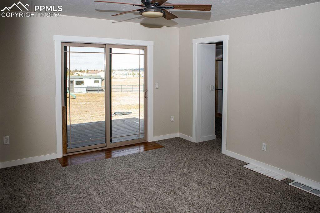 5630 Ramblin Rose Road Colorado Springs, CO 80908 - Photo 10 of 29 Main level primary bedroom with walkout
