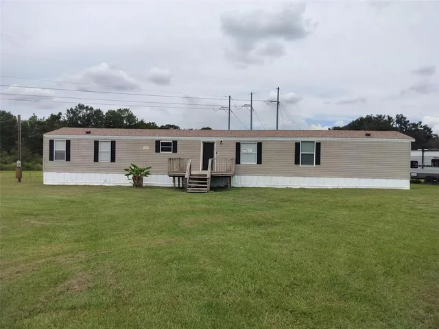 a view of a house with a backyard porch and sitting area