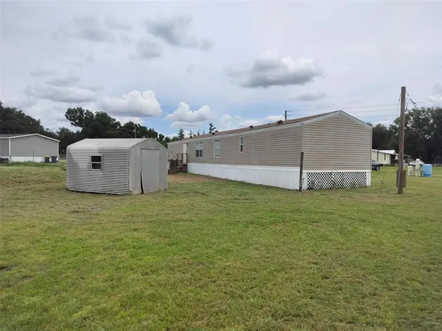 a view of a barn in the middle of a field