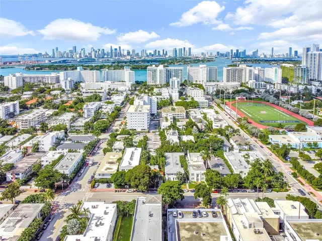 a kitchen with stainless steel appliances granite countertop a sink dishwasher a stove a microwave oven and white cabinets