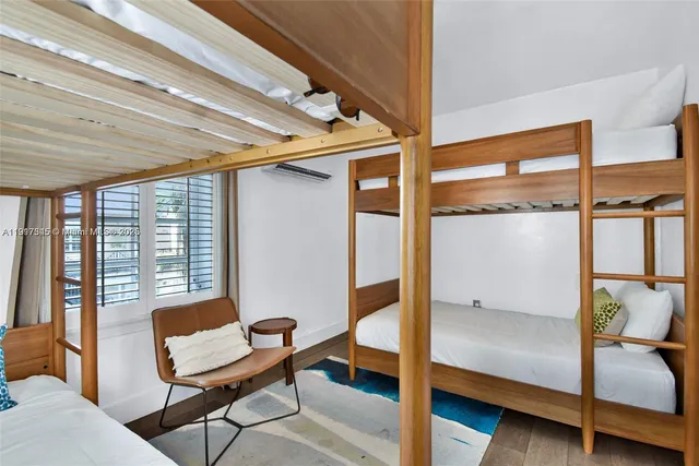 a bedroom with a bed and a potted plant