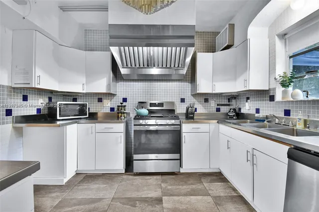 a kitchen with a sink stove and cabinets