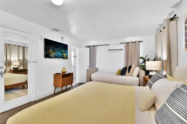 a living room with furniture a flat screen tv and a window