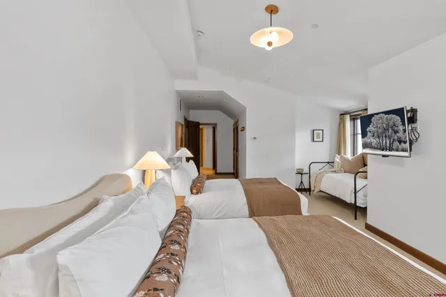 a bed room with a bed and a chandelier