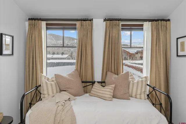 a bedroom with bed and a window