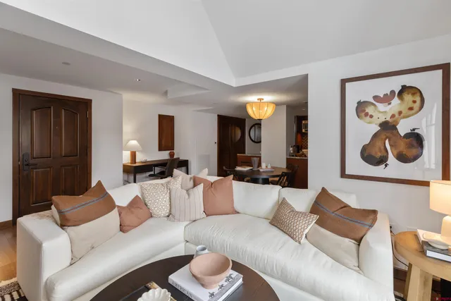 a living room with furniture and a lamp