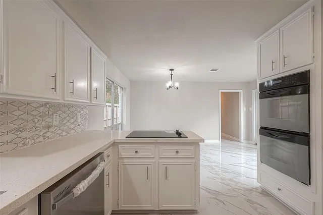 a view of a kitchen with refrigerator and cabinets