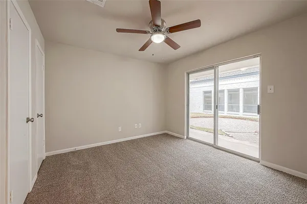 a view of an empty room and a ceiling fan