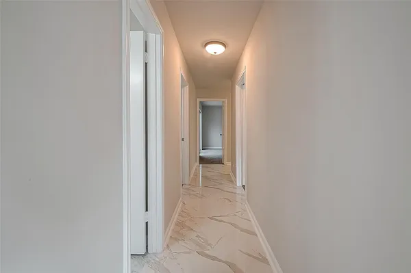 a view of a hallway with a door