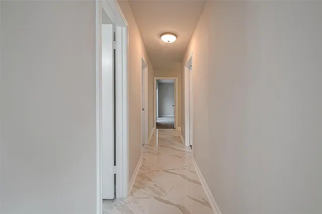 a view of a hallway with a door