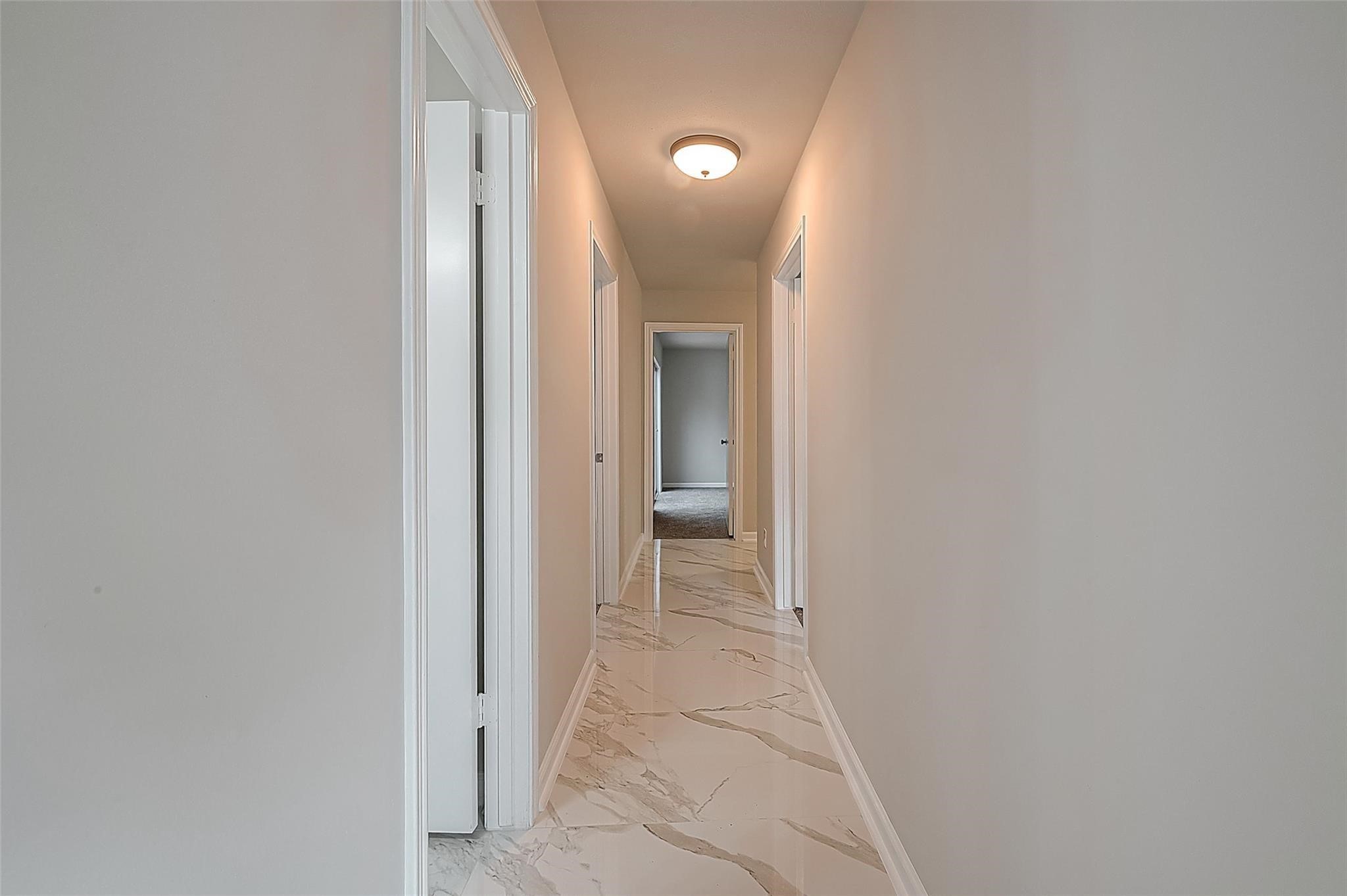 10811 Villa Lea Lane Houston, TX 77071 - Photo 24 of 34 a view of a hallway with wooden floor