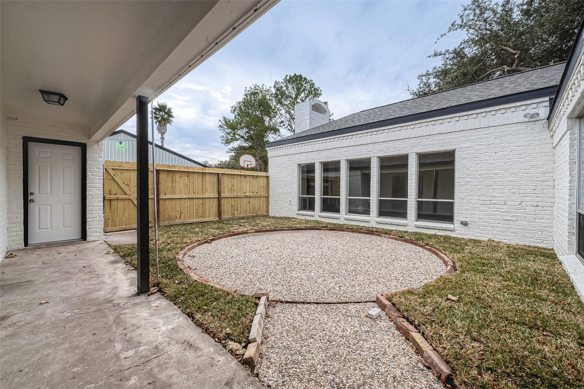 10811 Villa Lea Lane Houston, TX 77071 - Photo 32 of 34 a view of backyard with large windows and plants