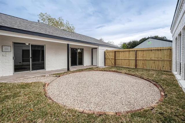 a backyard of a house with wooden fence
