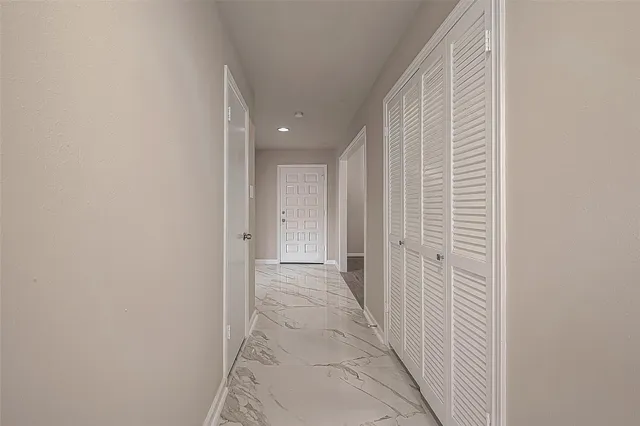 a view of a chandelier fan and wooden floor