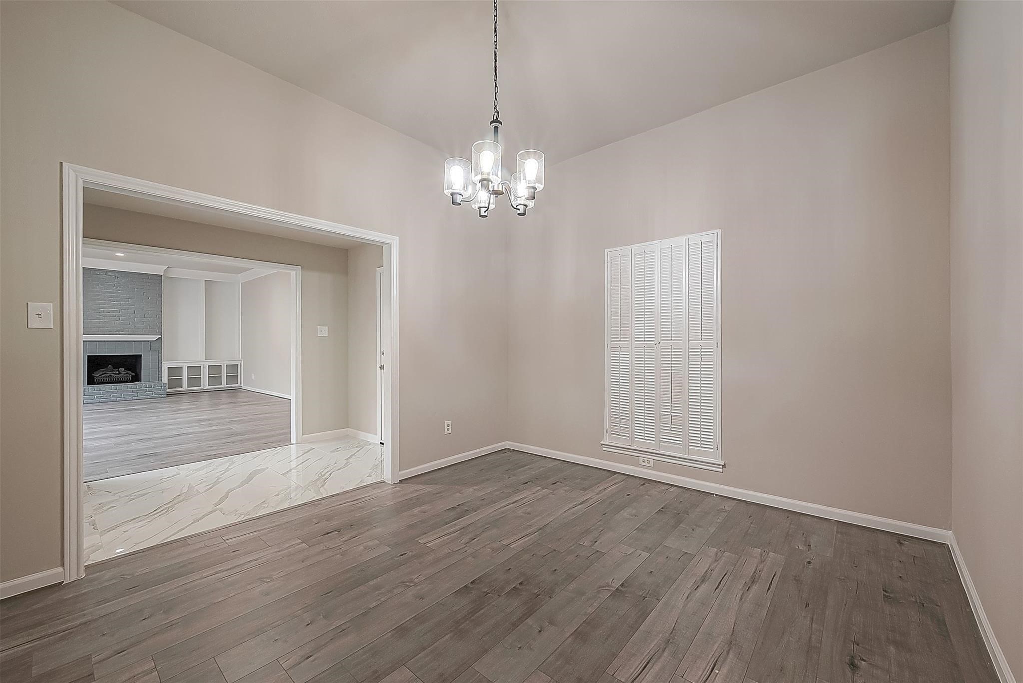 10811 Villa Lea Lane Houston, TX 77071 - Photo 5 of 34 a view of a chandelier fan and wooden floor