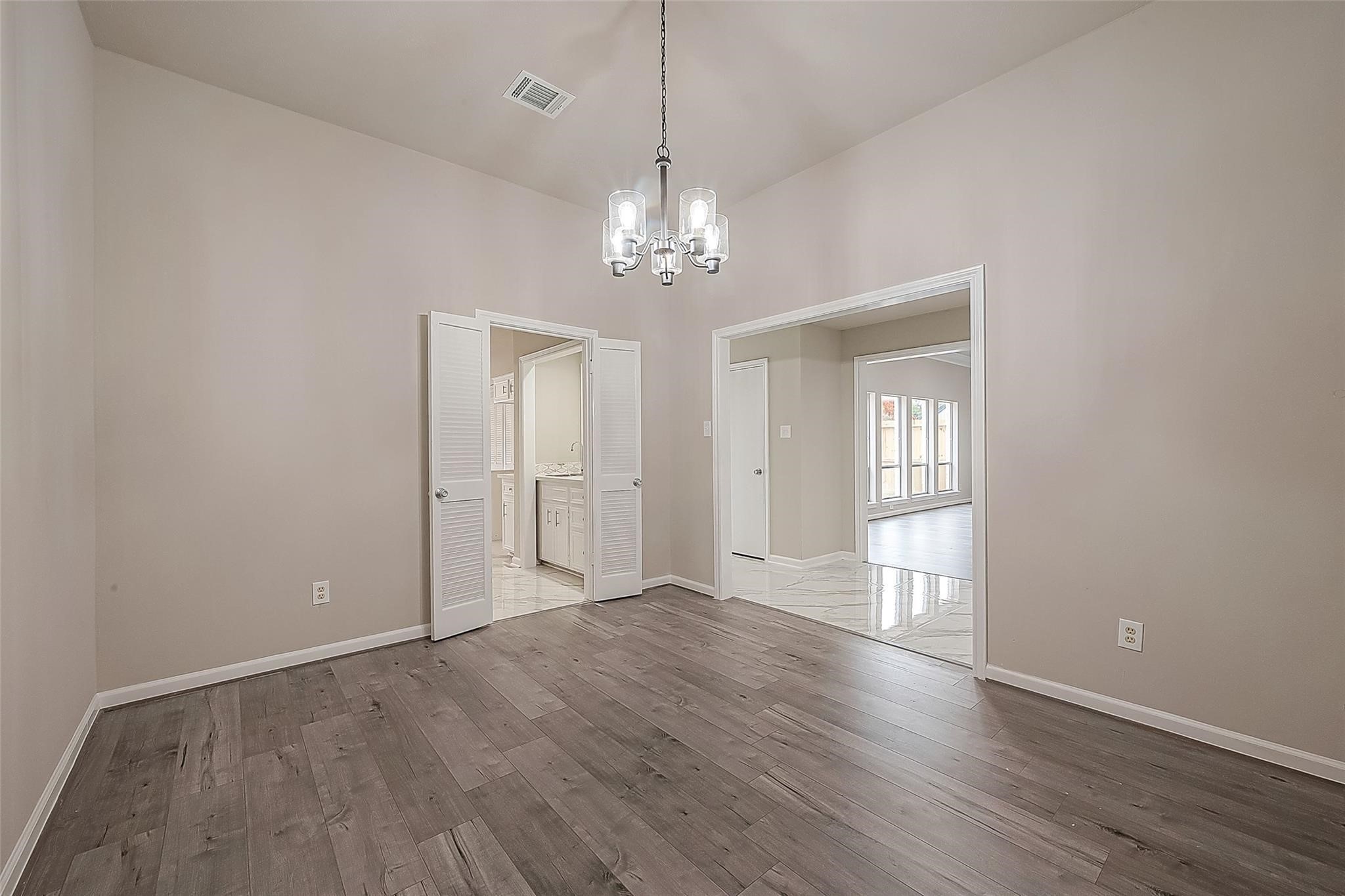 10811 Villa Lea Lane Houston, TX 77071 - Photo 6 of 34 a view of an empty room with wooden floor and a window
