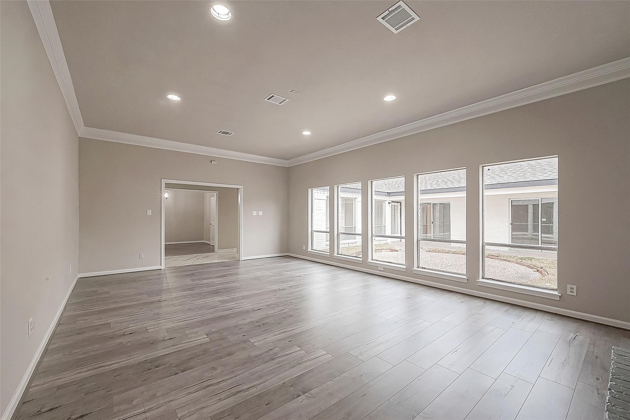 10811 Villa Lea Lane Houston, TX 77071 - Photo 9 of 34 a view of an empty room with wooden floor and window