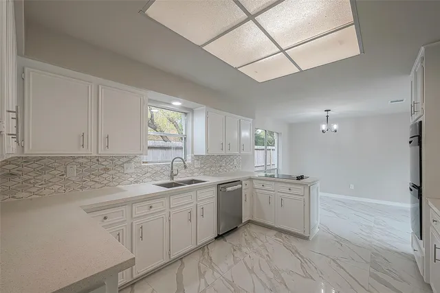 a kitchen with granite countertop a refrigerator stove and sink
