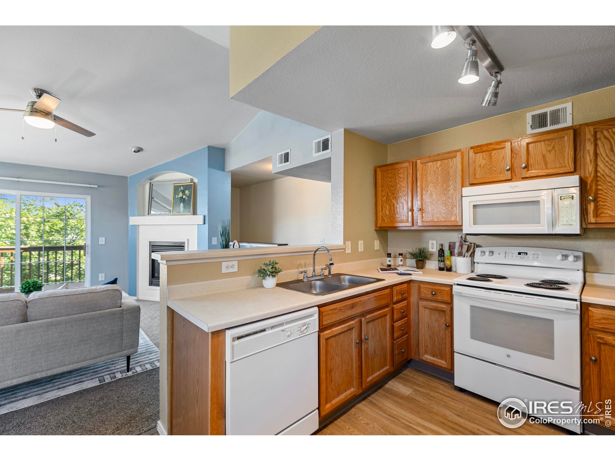 3002 West Elizabeth Street, Unit G Fort Collins, CO 80521 - Photo 14 of 28 a kitchen with a sink stove and cabinets