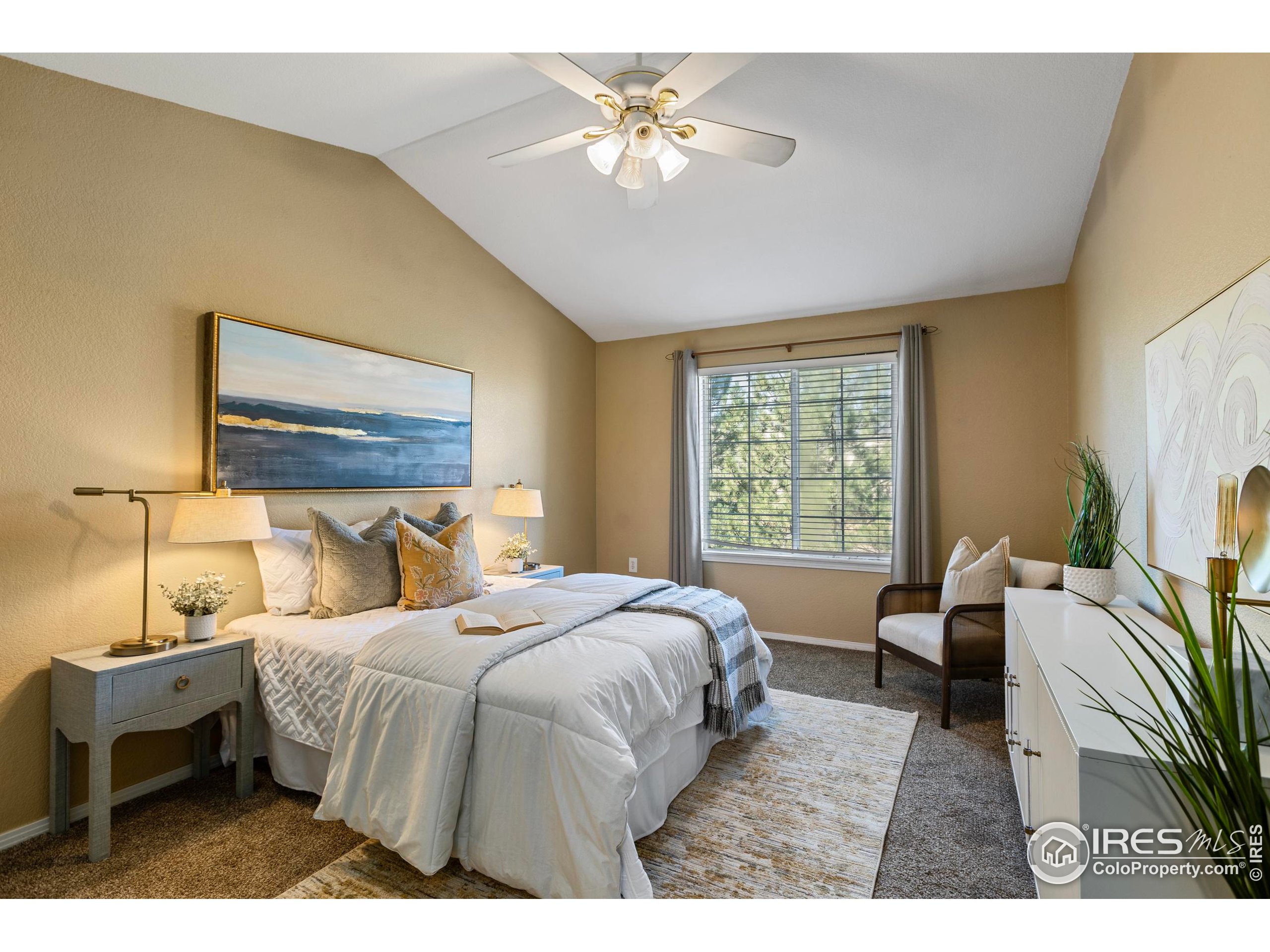 3002 West Elizabeth Street, Unit G Fort Collins, CO 80521 - Photo 17 of 28 a bedroom with a bed and a chandelier