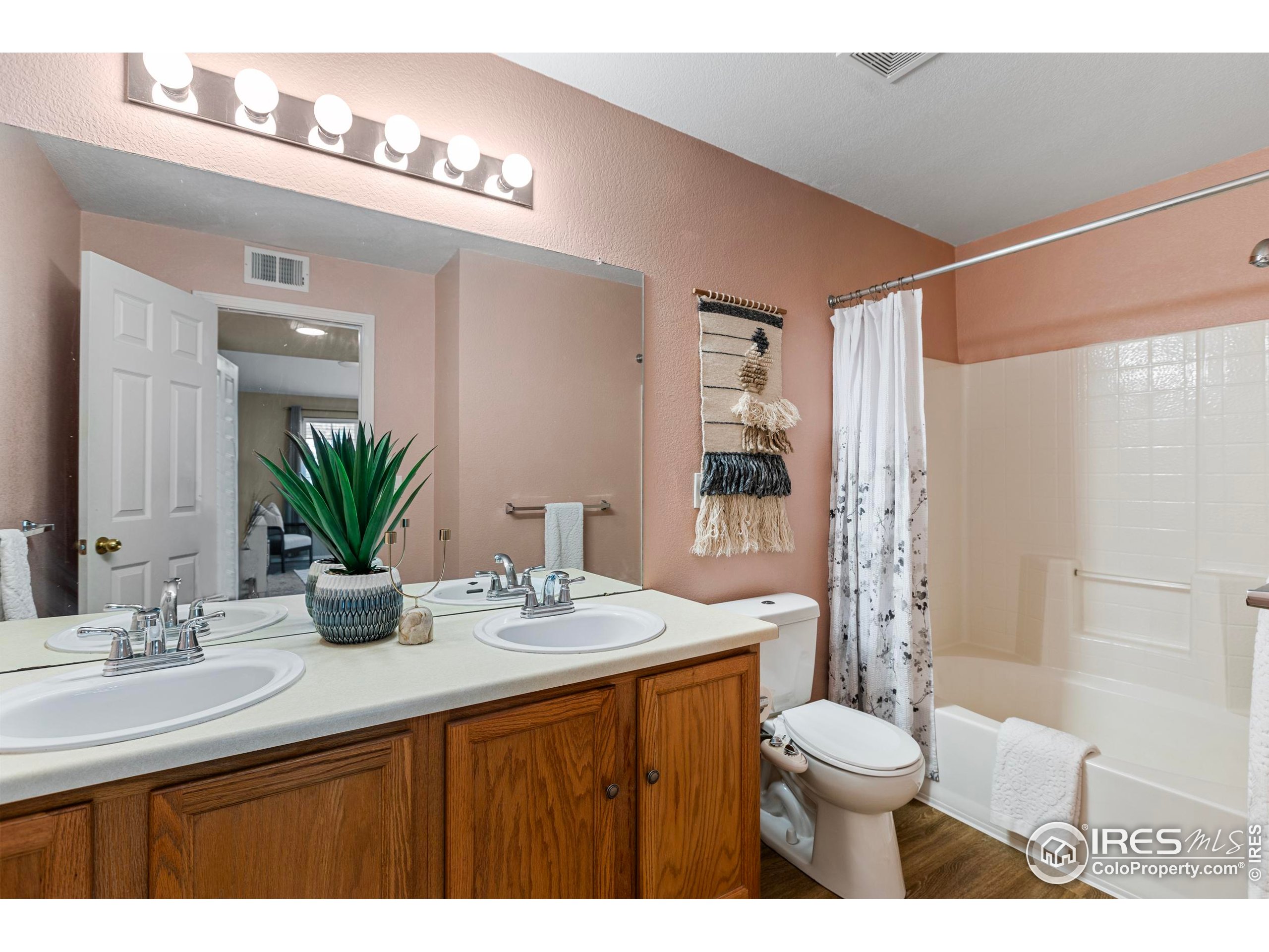 3002 West Elizabeth Street, Unit G Fort Collins, CO 80521 - Photo 18 of 28 a bathroom with a sink a toilet a mirror and shower