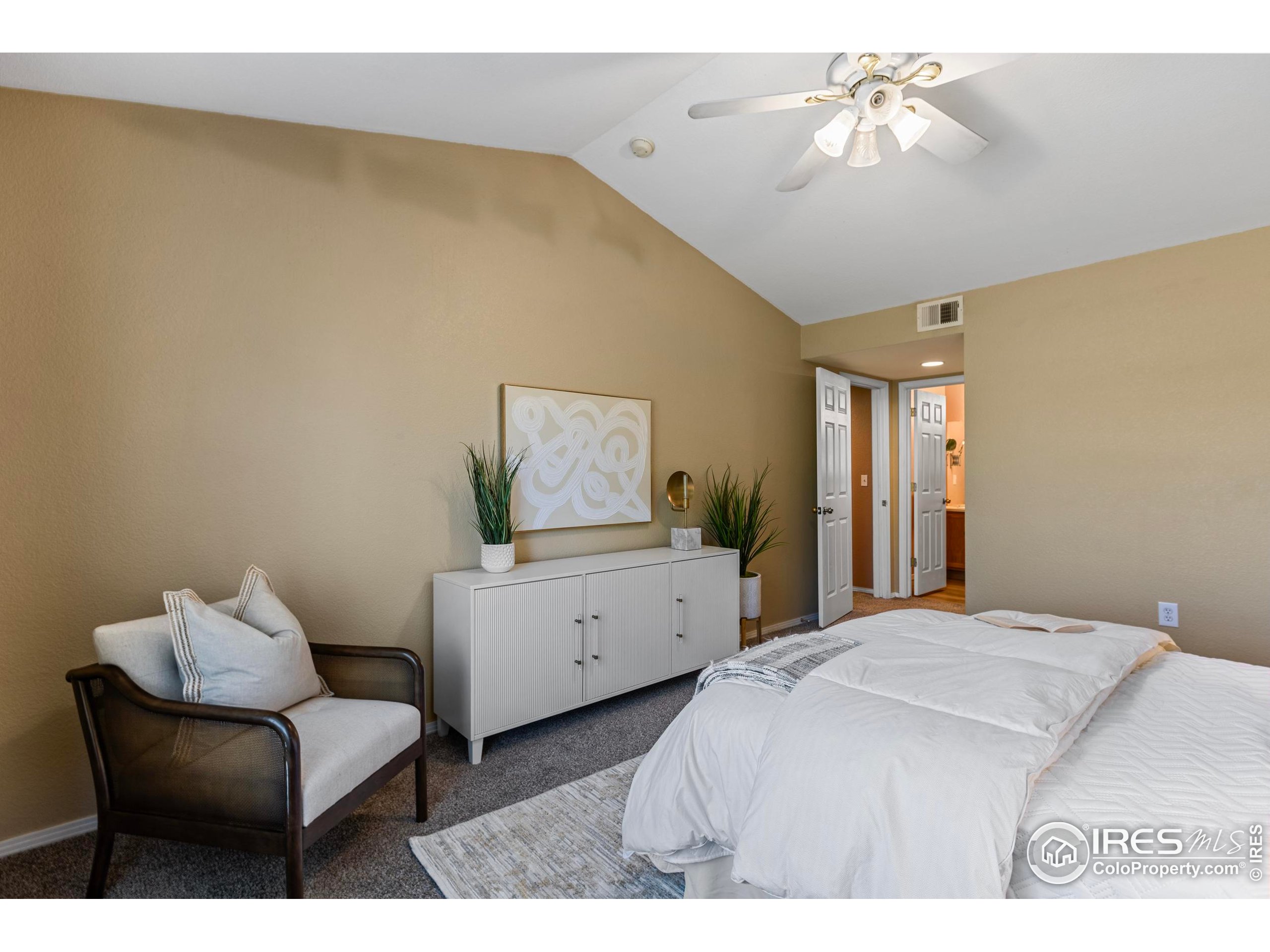 3002 West Elizabeth Street, Unit G Fort Collins, CO 80521 - Photo 19 of 28 a bedroom with a bed and a chandelier