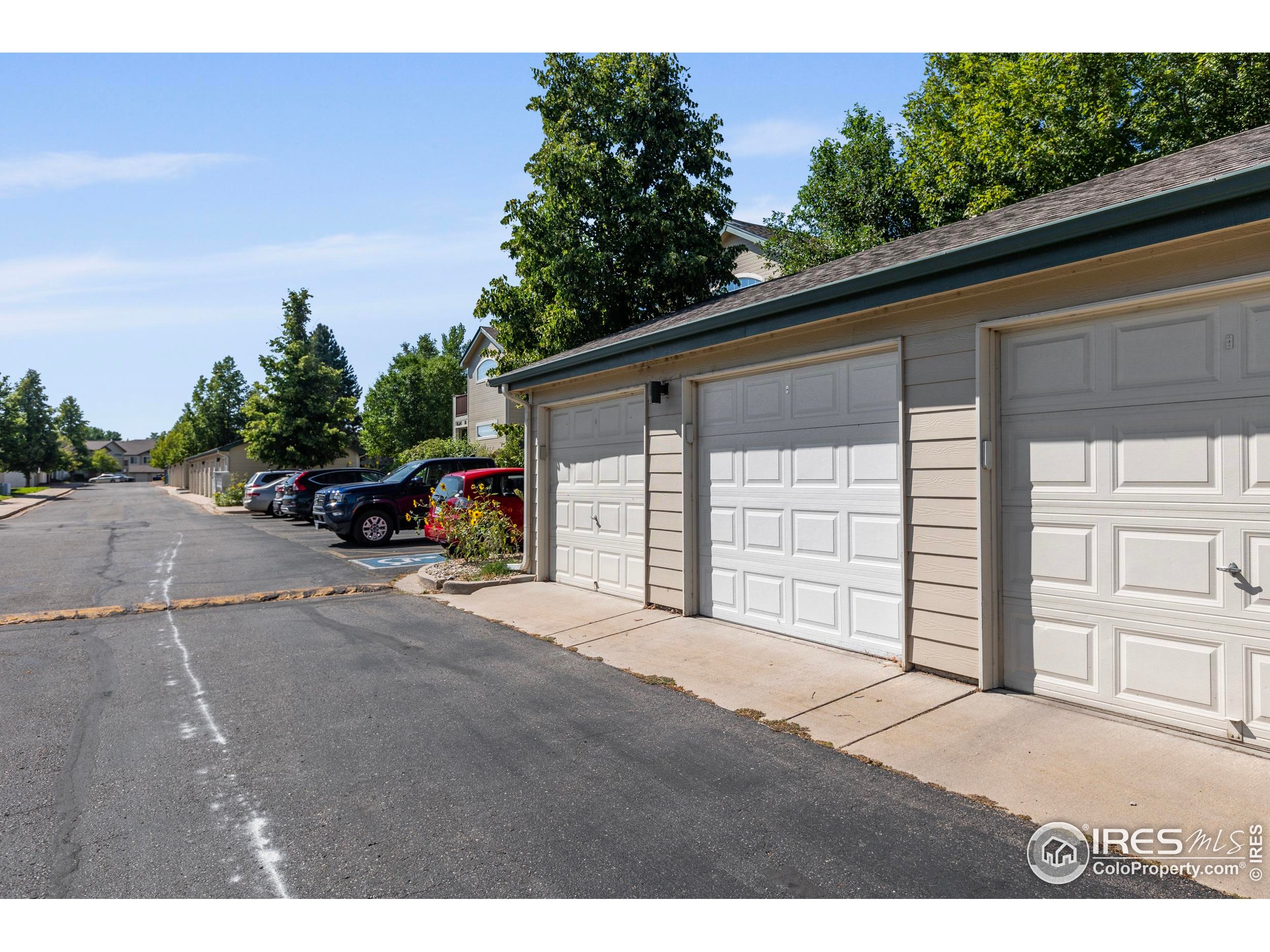 3002 West Elizabeth Street, Unit G Fort Collins, CO 80521 - Photo 25 of 28 a front view of a house with a yard and garage
