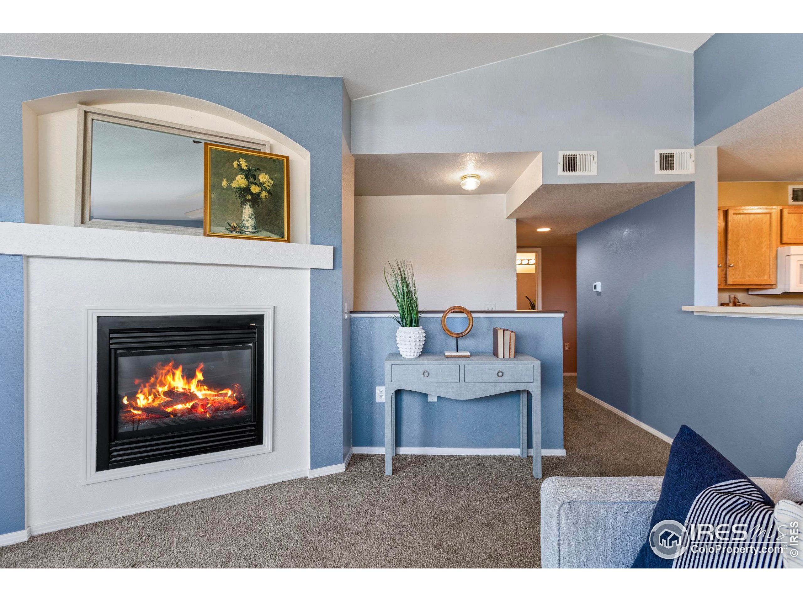 3002 West Elizabeth Street, Unit G Fort Collins, CO 80521 - Photo 8 of 28 a living room with furniture a fireplace and a fireplace