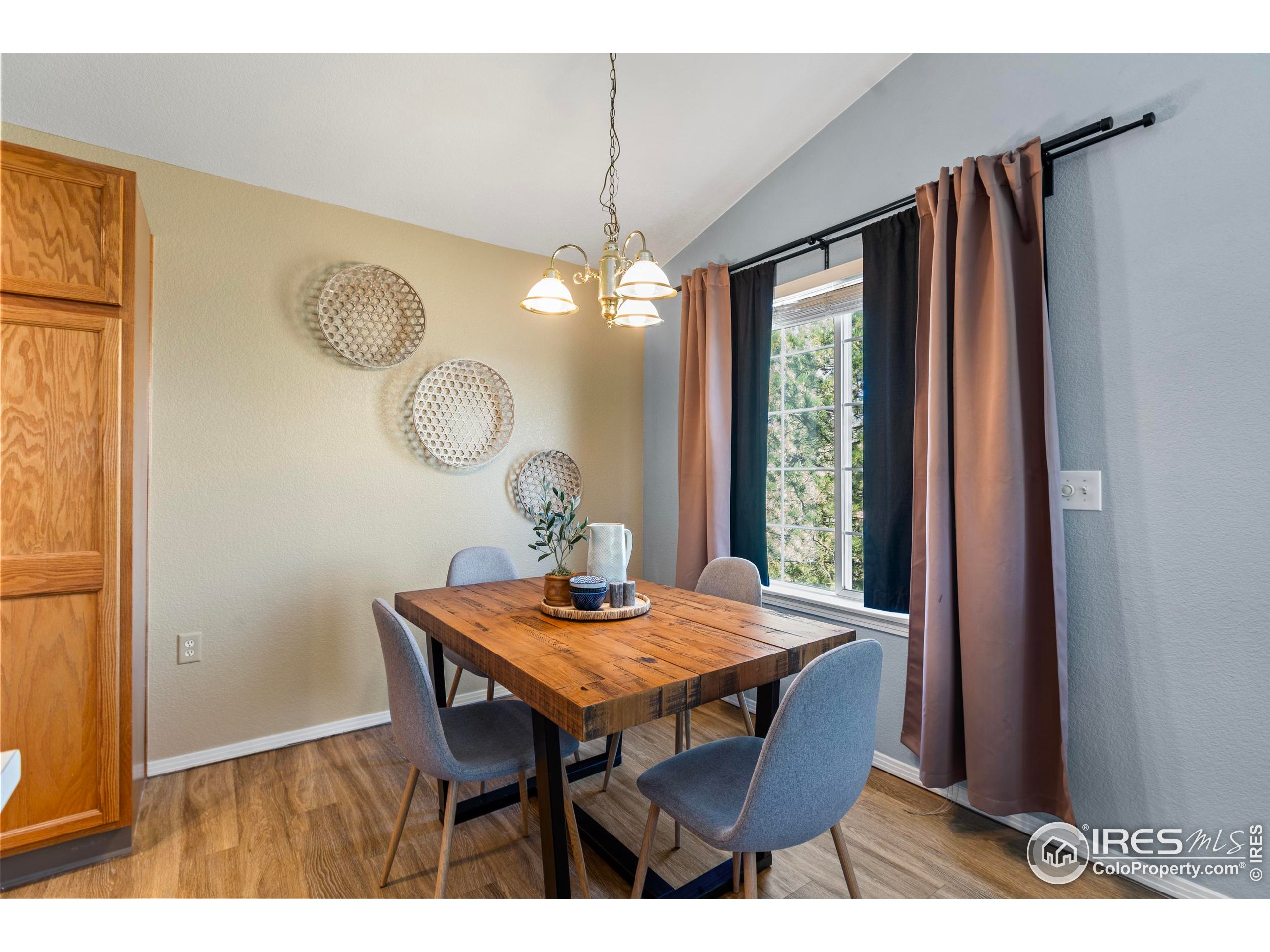 3002 West Elizabeth Street, Unit G Fort Collins, CO 80521 - Photo 9 of 28 a view of a dining room with furniture window and wooden floor