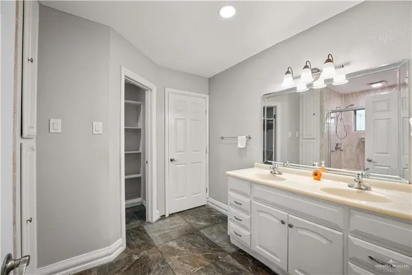 a bathroom with a double vanity sink mirror and