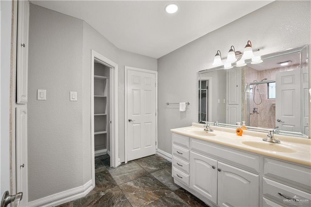2200 East 19th Street Mission, TX 78572 - Photo 11 of 12 a bathroom with a double vanity sink mirror and