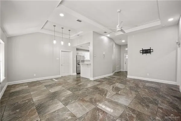 a view of an empty room with a ceiling fan