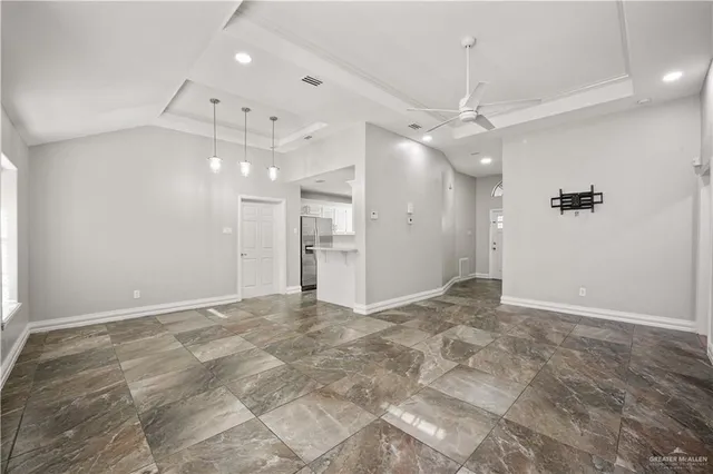 a view of an empty room with a ceiling fan