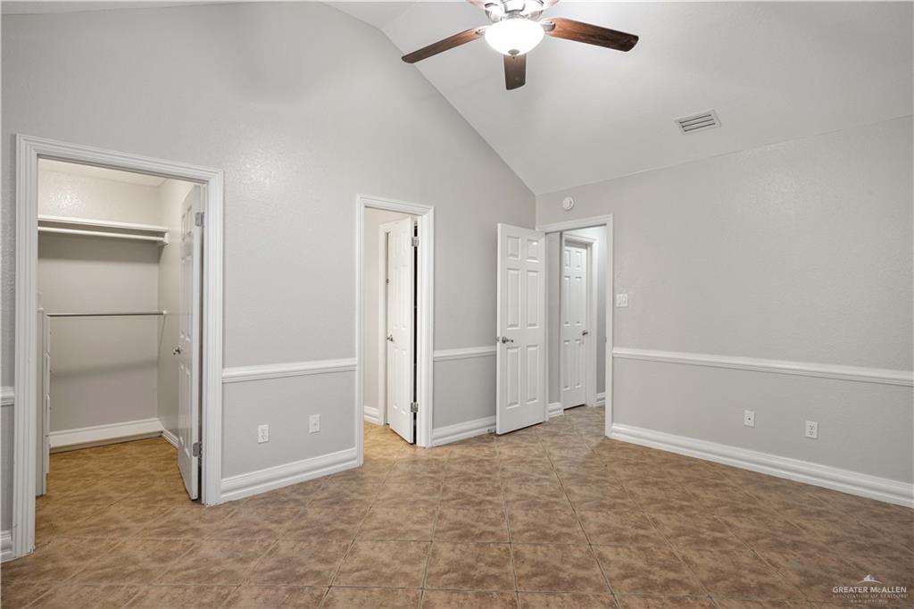 2200 East 19th Street Mission, TX 78572 - Photo 7 of 12 an empty room with closet and a chandelier fan