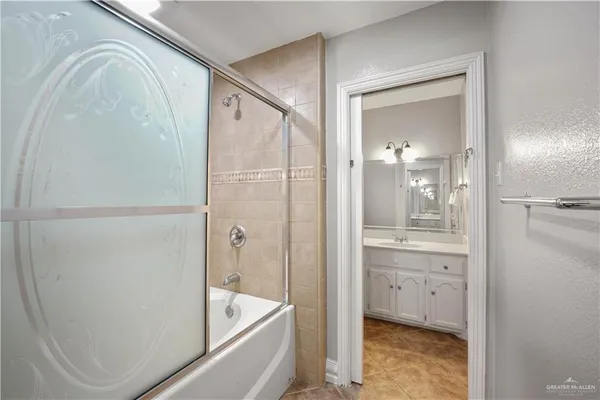 a bathroom with a tub a sink and mirrors