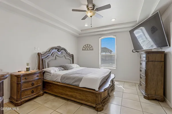 a bedroom with a bed and a ceiling fan