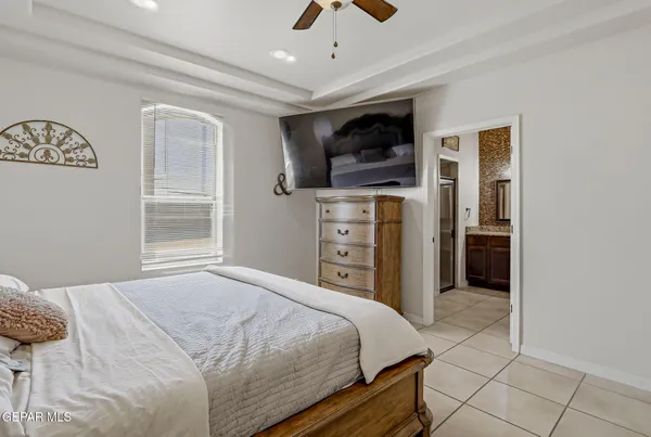 a bedroom with a bed and a television