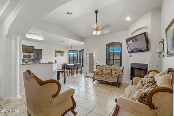 a living room with furniture a fireplace and a flat screen tv