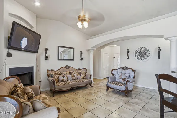 a living room with furniture a couch and a chandelier