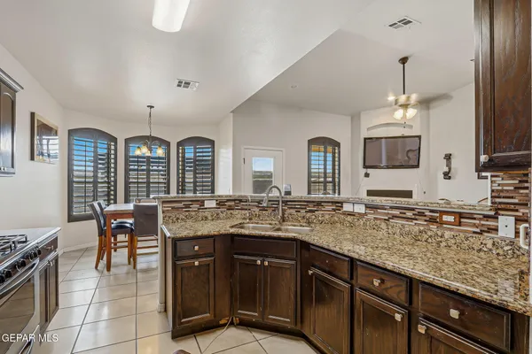 a kitchen with center island table and chairs