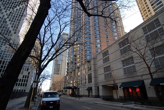 a city street with tall buildings and trees