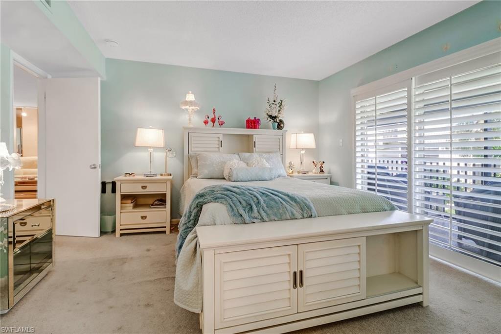 788 Park Shore Drive, Unit E32 Naples, FL 34103 - Photo 18 of 35 a bedroom with a bed and a window