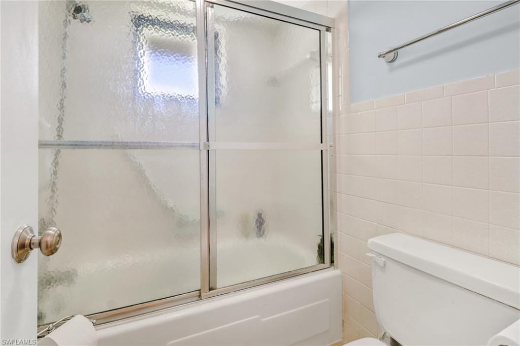 788 Park Shore Drive, Unit E32 Naples, FL 34103 - Photo 20 of 35 a bathroom with a shower and a toilet