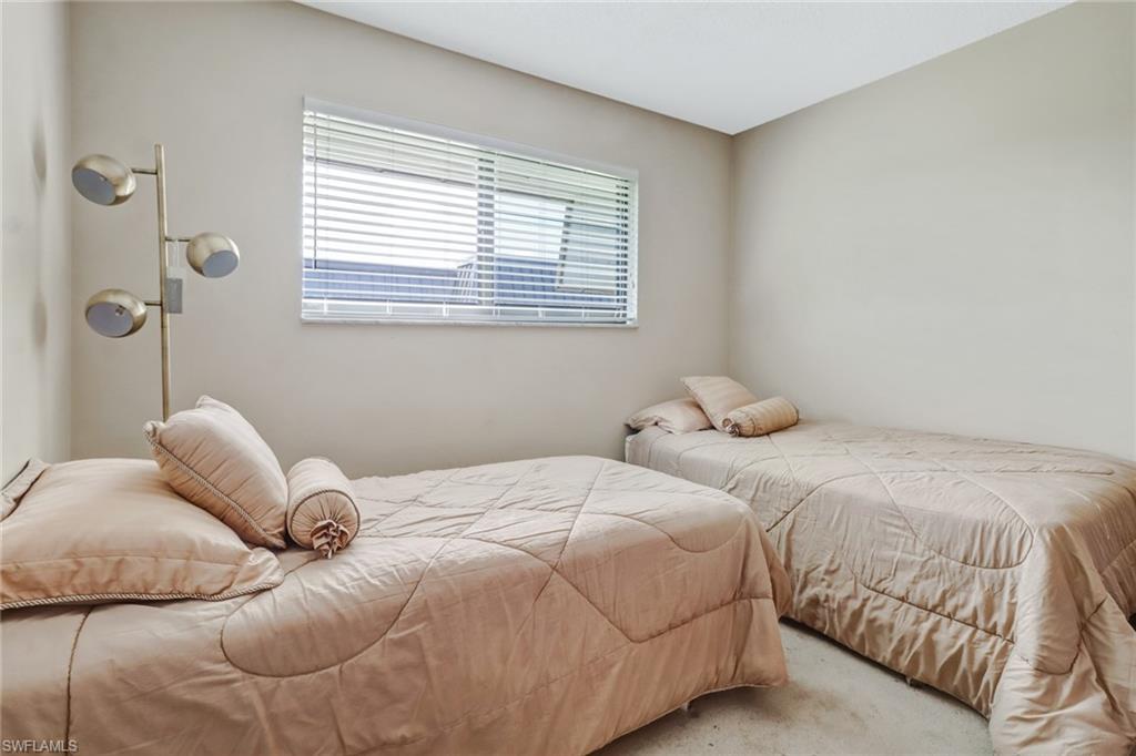 788 Park Shore Drive, Unit E32 Naples, FL 34103 - Photo 21 of 35 a bedroom with a bed and a window