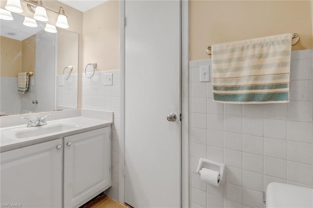 788 Park Shore Drive, Unit E32 Naples, FL 34103 - Photo 23 of 35 a bathroom with a sink a toilet and shower
