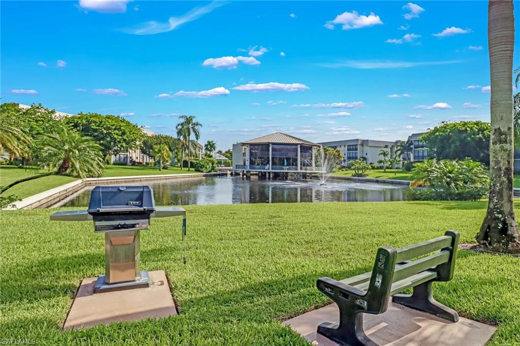 788 Park Shore Drive, Unit E32 Naples, FL 34103 - Photo 25 of 35 a view of a chairs in a patio with a yard