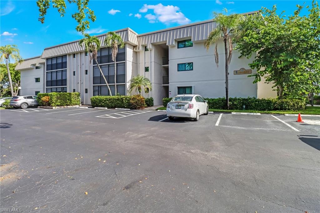 788 Park Shore Drive, Unit E32 Naples, FL 34103 - Photo 3 of 35 a car parked in front of a building